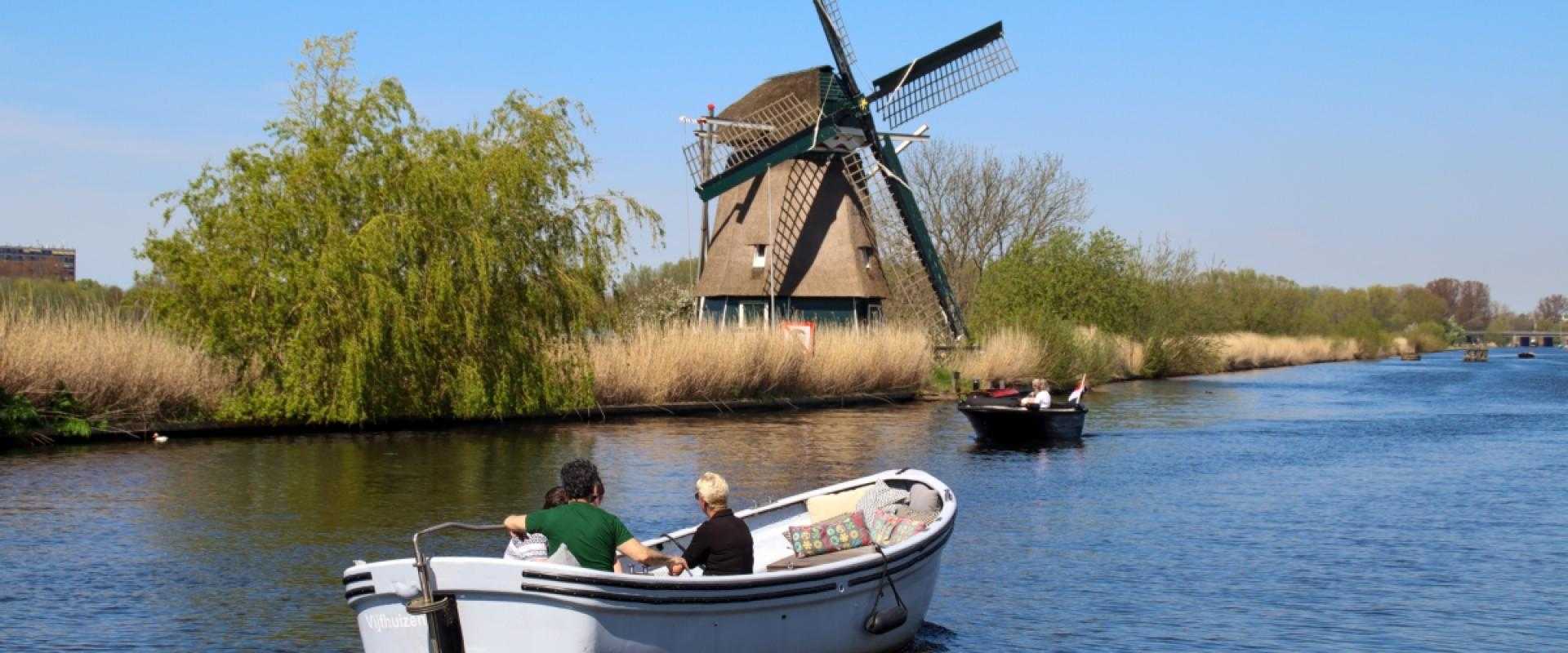 Sailing on the ring canal with a windmill in the background