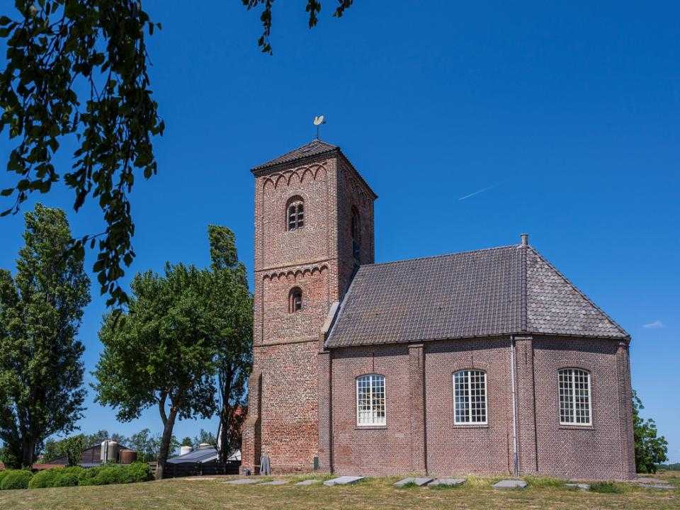 Buitenkant Stompe Toren tussen bomen door gezien