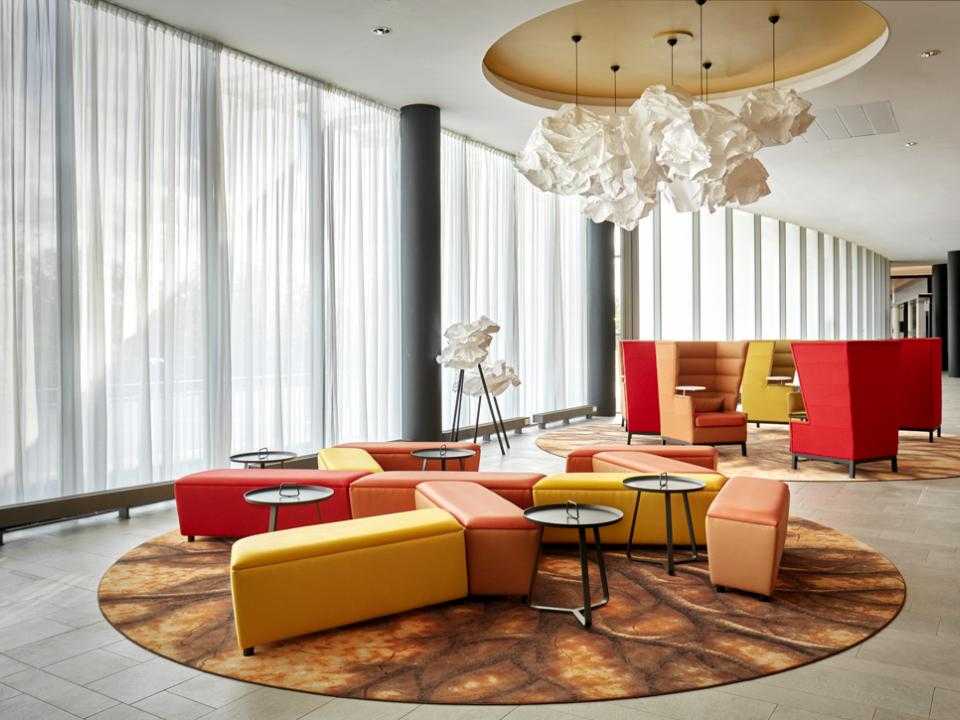 Lobby Park Plaza with yellow, red and orange seats on a round carpet