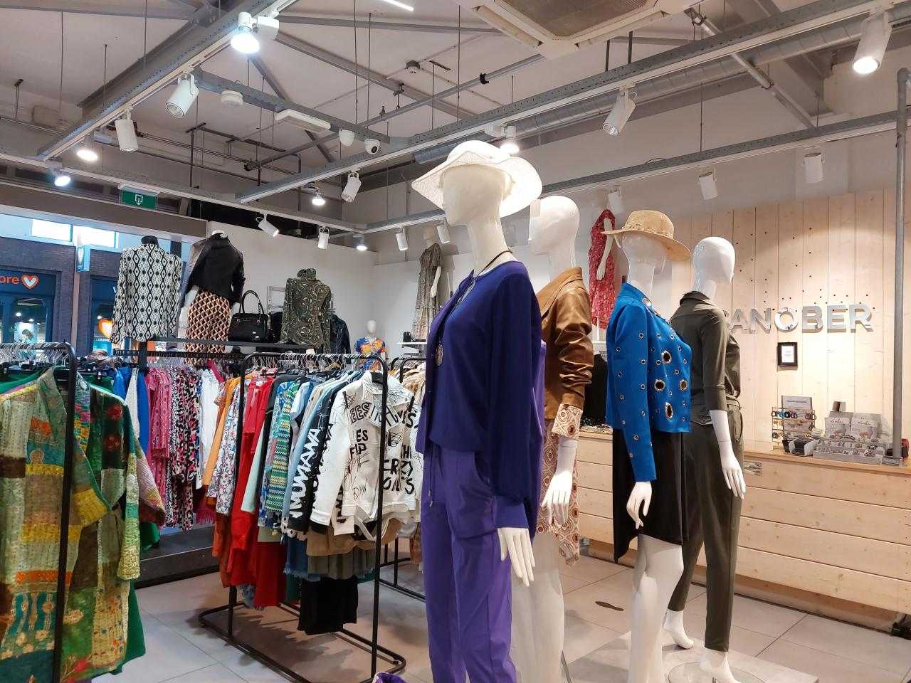 Shop interior with mannequins and clothes racks