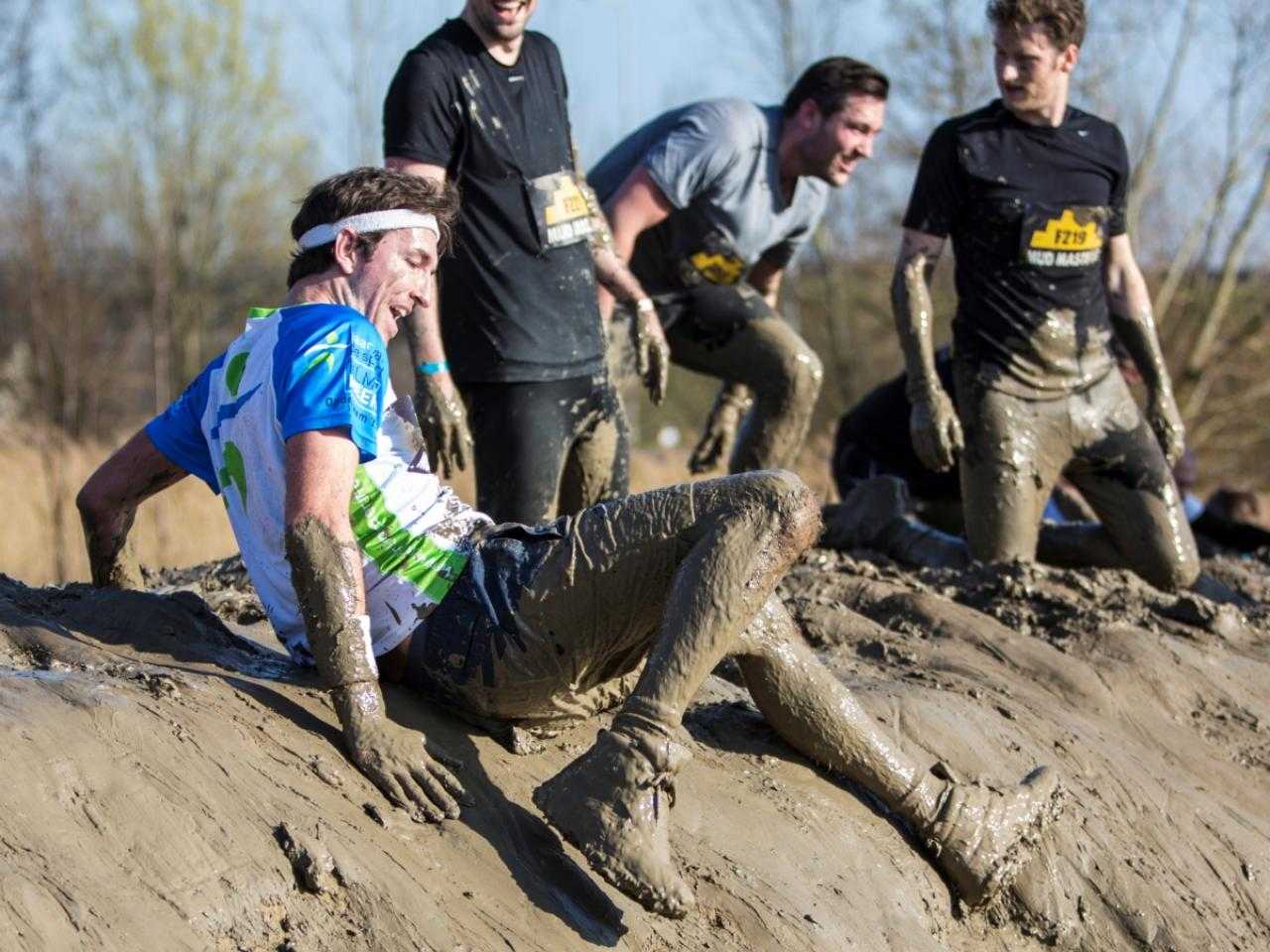 Participants at Mud Masters at sloping slope with mud