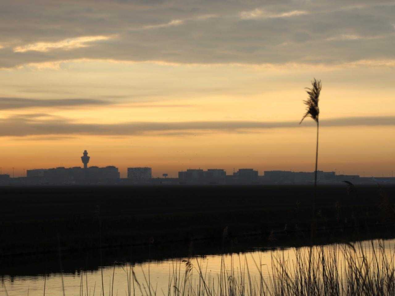 Schiphol tijdens een zonsondergang