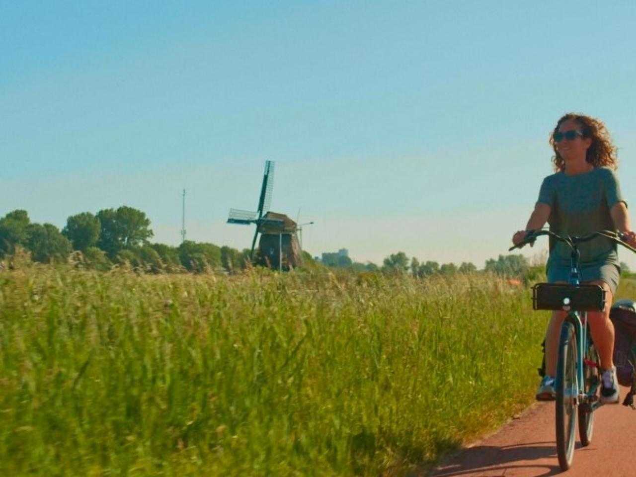 Cycling on the Ringdijk with a windmill in the background