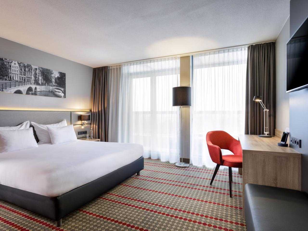 Interior hotel room with desk and red chair Ramada hotel